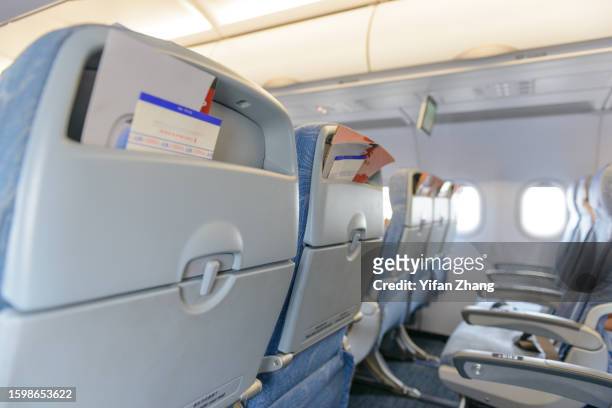 empty airplane cabin interior - economy class stock-fotos und bilder