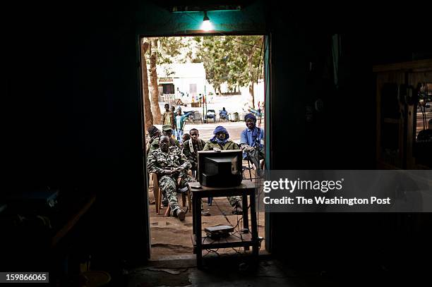 Malian soldiers watch a soccer match in the Africa Cup of Nations in the town of Niono, near the frontline on January 20, 2013. For the last week,...