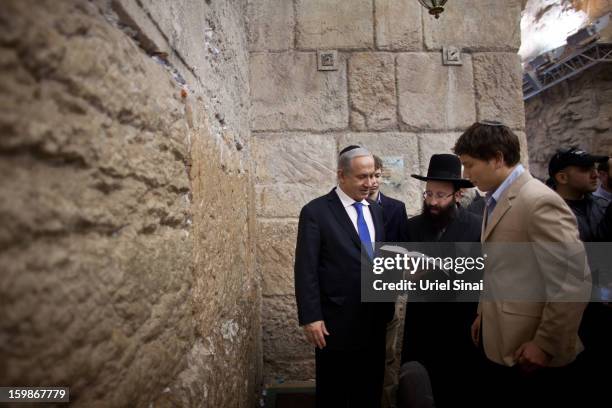 Israeli Prime Minister Benjamin Netanyahu prays with his sons Yair Netanyahu and Avner Netanyahu at the Western Wall, Judaism holiest site, on...