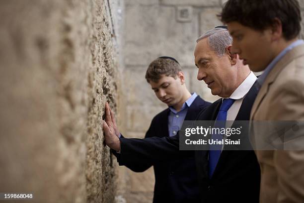 Israeli Prime Minister Benjamin Netanyahu prays with his sons Yair and Avner at the Western Wall, Judaism holiest site on January 22, 2013 in...