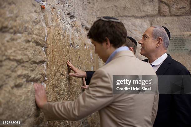 Israeli Prime Minister Benjamin Netanyahu prays with his sons Yair and Avner at the Western Wall, Judaism holiest site on January 22, 2013 in...