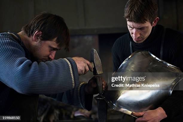 Blacksmith Georg and Johann Schmidberger Jun. Of the Schmiede Schmidberger blacksmiths crafts a piece of metal that will become part of a new suit of...