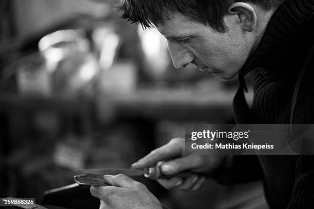 Blacksmith Johann Schmidberger Junior of the Schmiede Schmidberger blacksmiths crafts a piece of metal that will become part of a new suit of armour...