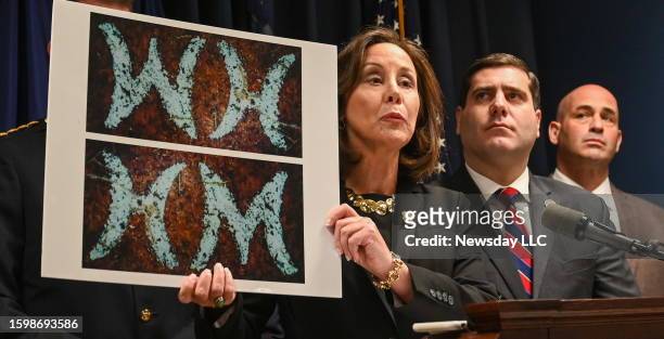 During a press conference in Yaphank, New York, Suffolk County police commissioner Geraldine Hart holds up a picture of a belt that investigators...