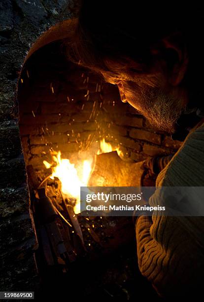 Blacksmith Johann Schmidberger Sen. Of the Schmiede Schmidberger blacksmiths crafts a piece of metal that will become part of a new suit of armour...