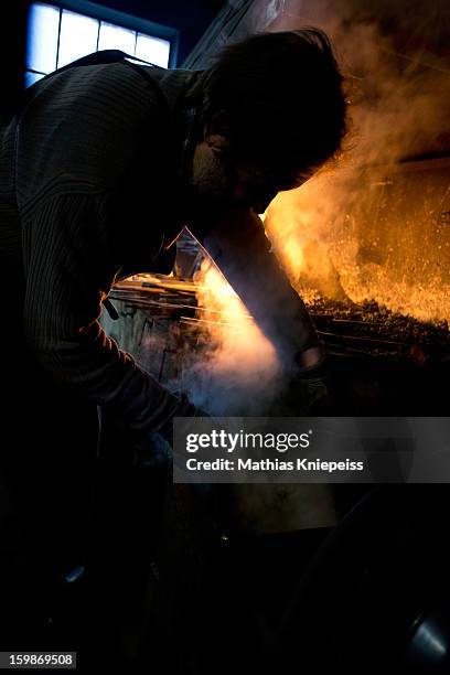 Blacksmith Johann Schmidberger Sen. Of the Schmiede Schmidberger blacksmiths crafts a piece of metal that will become part of a new suit of armour...