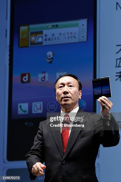 Kaoru Kato, president and chief executive officer of NTT DoCoMo Inc., introduces the company's Medias W N-05E smartphone, manufactured by NEC Casio...