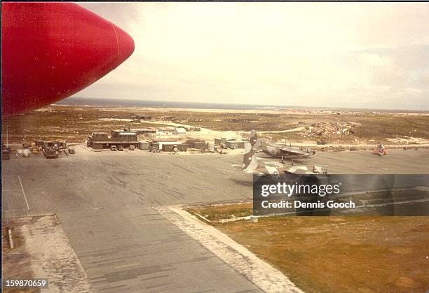 Overflying Stanley Airfield in a Brittan Norman Islander. November 1983 with two C130 Hercules Aircraft on the Airfield.