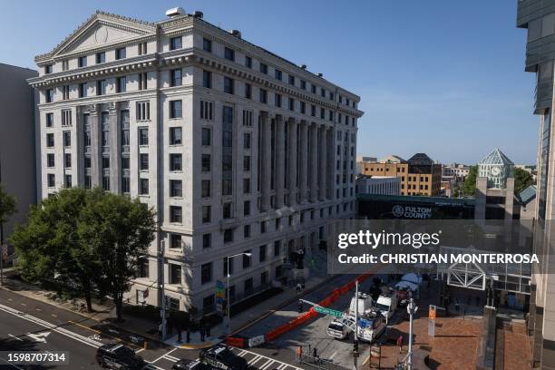 Police officers and media members surround the Lewis R. Slaton Courthouse ahead of an expected indictment of former US President Donald Trump in...