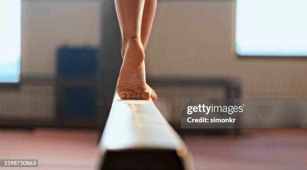 gymnast woman performing on balance beam - walking balance beam stock pictures, royalty-free photos & images