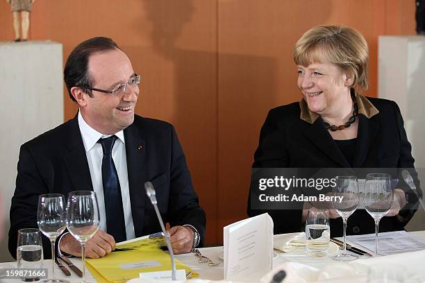 French President Francois Hollande and German Chancellor Angela Merkel arrive for a joint council meeting at the German federal chancellery during...