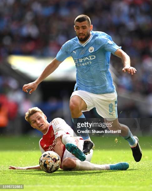 Mateo Kovacic of Manchester City is tackled by Martin Odegaard of Arsenal during The FA Community Shield match between Manchester City against...