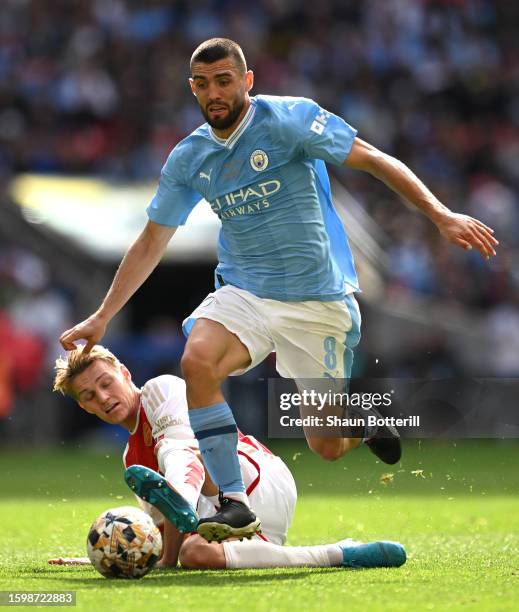 Mateo Kovacic of Manchester City is tackled by Martin Odegaard of Arsenal during The FA Community Shield match between Manchester City against...