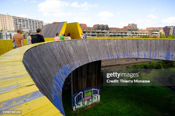 People enjoy the Luchtsingel , a 400-meter-long pedestrian bridge that runs through a building and across roads and railways to connect three...