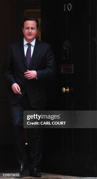 British Prime Minister David Cameron prepares to greet Emir of Qatar Sheikh Hamad bin Khalifa al-Thani at 10 Downing Street in central London on...