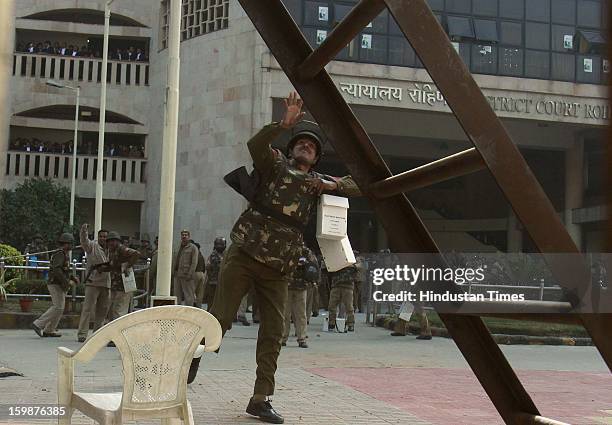 Police use tear gas to control supporters of INLD after a violence erupted outside Rohini Court in support of Om Prakash Chautala as court was giving...