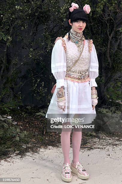 Canadian artist Claire Boucher aka Grimes poses during a photocall prior to attend the Chanel Haute Couture Spring-Summer 2013 collection shows on...