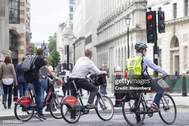 Commuters on bikes wait at a junction in The City of London, UK, on Monday, Aug. 14, 2023. Average earnings excluding bonuses rose 7.3% in the year...