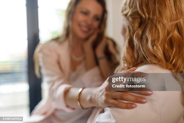 woman holding her hand on mother's shoulder while bonding - hand patting stock pictures, royalty-free photos & images