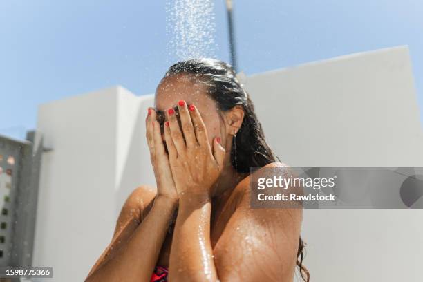 unrecognizable woman refreshing herself - bath shower stock pictures, royalty-free photos & images