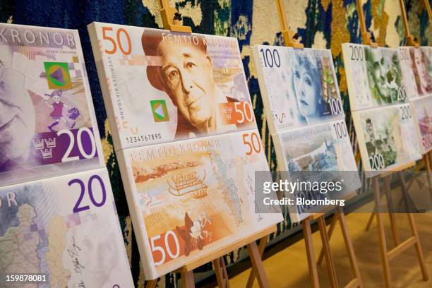 Artwork showing the designs of new folding Swedish krona, or kronor, currency notes due to be issued in 2014 stands on display at the Riksbank in...