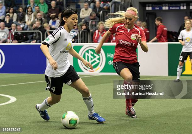 Saki Kumagai of 1.FFC Frankfurt challenges Kristina Gessat of FSV Guetersloh 2009 during the DFB Women's Indoor Cup 2013 at the GETEC-Arena on...