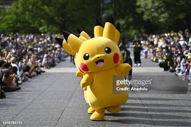 People in Pikachu costumes are seen during the Pokemon Parade in Minato Mirai district of Yokohama, Japan on august 14, 2023. Families, fans, locals...