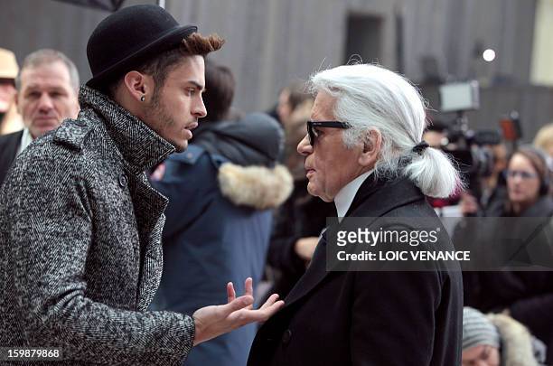 French model Baptiste Giabiconi talks with German designer Karl Lagerfeld during the Chanel Haute Couture Spring-Summer 2013 collection shows on...
