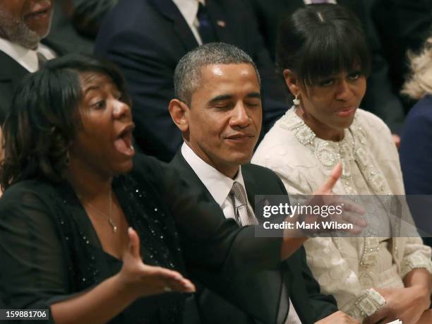 President Barack Obama closes his eyes while he and first lady Michelle Obama listen to Michele Fowlin direct the Children of the Gospel Choir during...