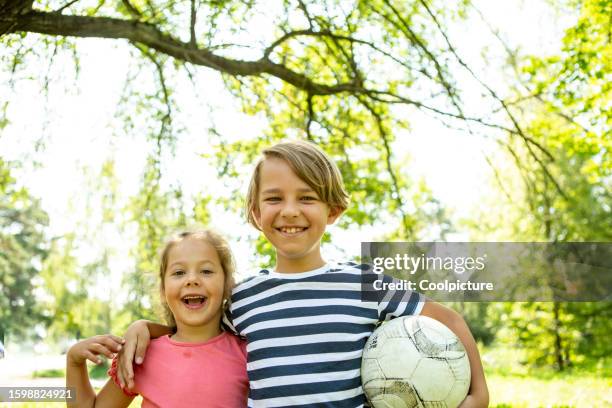 portrait of happy children with soccer - real family stock pictures, royalty-free photos & images