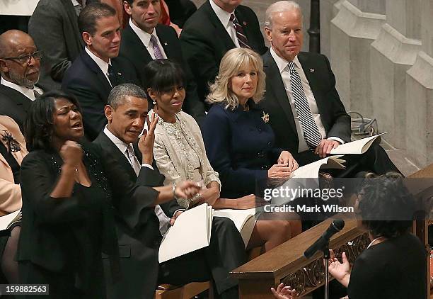 President Barack Obama wipes away a tear while he and first lady Michelle Obama , Dr. Jill Biden and Vice President Joseph Biden , listen to Michele...