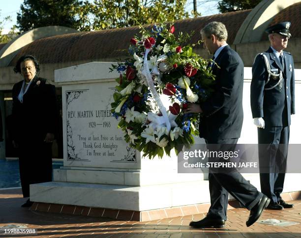 President George W. Bush lays at wreath at the grave of Dr Martin Luther King Jr, as his widow Coretta Scott King looks on 15 January 2004, at the...