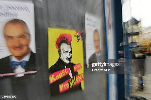 Campaign posters of Czech Presidential candidate Karel Schwarzenberg are displayed on a wall, one depicting him as a punk with red hair on January...