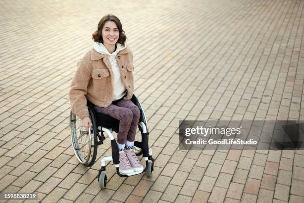 young woman in a wheelchair - paralysis stock pictures, royalty-free photos & images