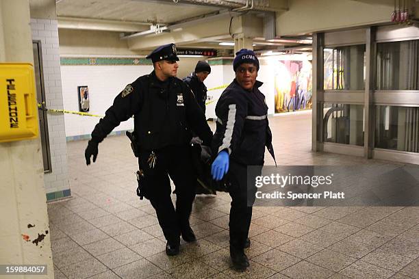 The body of an apparent suicide victim is brought up from a subway station in Times Square on January 22, 2013 in New York City. New York City has...