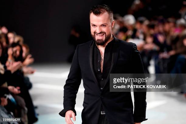 French designer Julien Fournie acknowledges the public at the end of his Haute Couture Spring-Summer 2013 collection show on January 22, 2013 in...