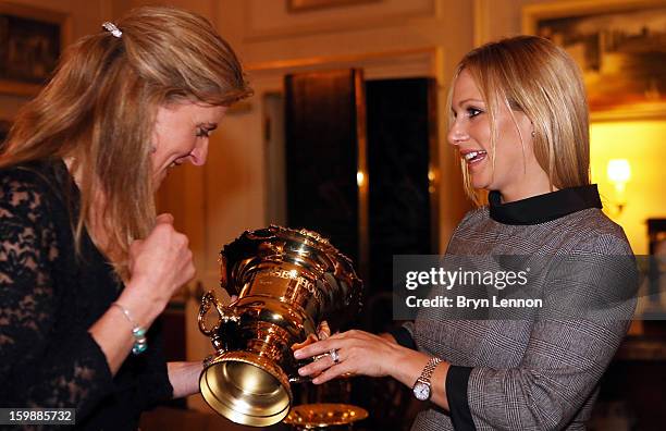 Tina Cook and Zara Phillips examine a trophy during a reception hosted by the Duchess of Cornwall for the British Equestrian Teams from the London...