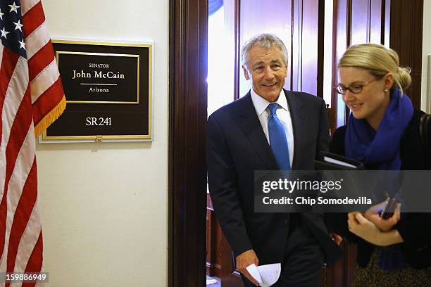 Accompanied by CIA Spokesperson Marie Harf , former U.S. Senator Chuck Hagel leaves the Capitol Hill offices of Sen. John McCain after the two...