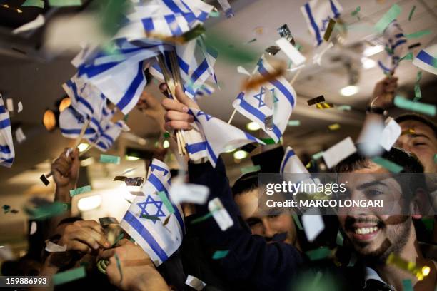 Supporters Naftali Bennett, head of the Israeli hard-line national religious party, Jewish Home, celebrate after exit polls were announced on January...