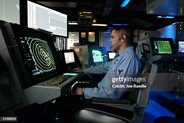 Keith Miller from Chandler, Arizona, works in front of a radar screen in the Carrier Air Traffic Control Center aboard the USS Abraham Lincoln...