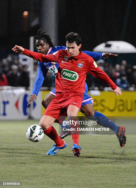 Vertou's Lionel Cottereau fights for the ball with Evian's Eric Tiebi during the French Cup football match Vertou against Evian on January 22, 2013...