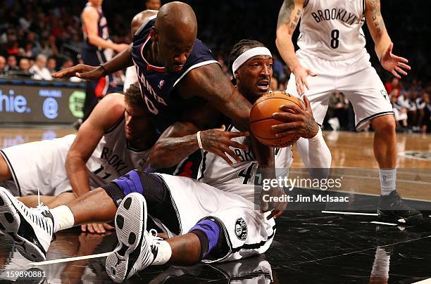 Gerald Wallace of the Brooklyn Nets in action against Johan Petro of the Atlanta Hawks at Barclays Center on January 18, 2013 in the Brooklyn borough...