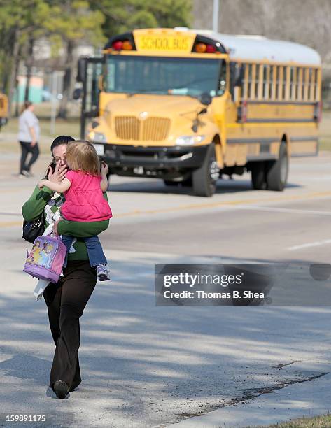 Tierna Tate carries her 19th month old daughter Olivia Tate after she picked her up for the Lone Star College Daycare on January 22, 2013 in The...