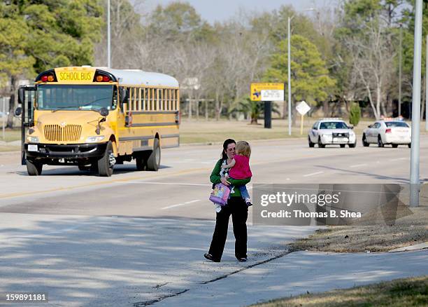 Tierna Tate carries her 19th month old daughter Olivia Tate after she picked her up for the Lone Star College Daycare on January 22, 2013 in The...