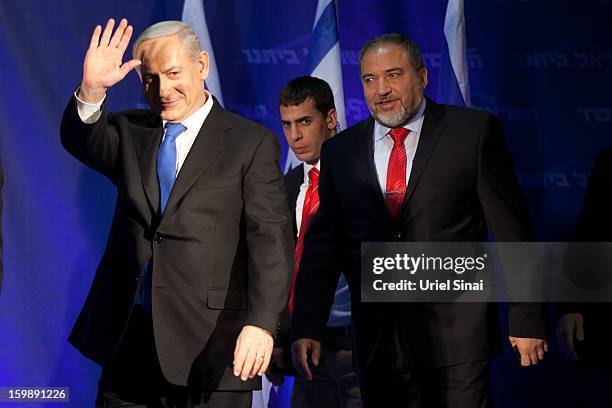 Israeli Prime Minister Benjamin Netanyahu waves to his supporters as he arrives with Former Israel Minister for Foreign Affairs Avigdor Liberman at...