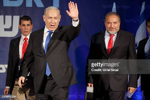 Israeli Prime Minister Benjamin Netanyahu waves to his supporters as he arrives with Former Israel Minister for Foreign Affairs Avigdor Liberman at...