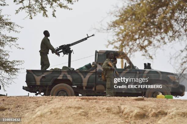 Malian soldiers stand guard on the road between Markala and Niono, on January 22, 2013. Mali's army chief today said his French-backed forces could...