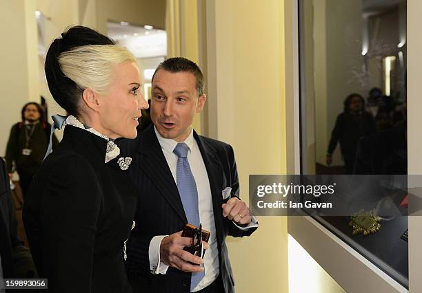 Jean-Marc Pontroue, CEO of Roger Dubuis talks to Daphne Guinness, friend of the brand as she visits the Roger Dubuis booth during the 23rd Salon...