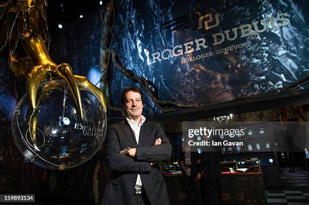 Gregory Bruttin, Director of movement development poses with the Excalibur Quatuor watch as he visits the Roger Dubuis booth during the 23rd Salon...