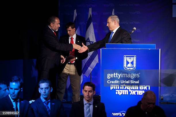 Israeli Prime Minister Benjamin Netanyahu shakes hands with Former Israel Minister for Foreign Affairs Avigdor Liberman at his election campaign...